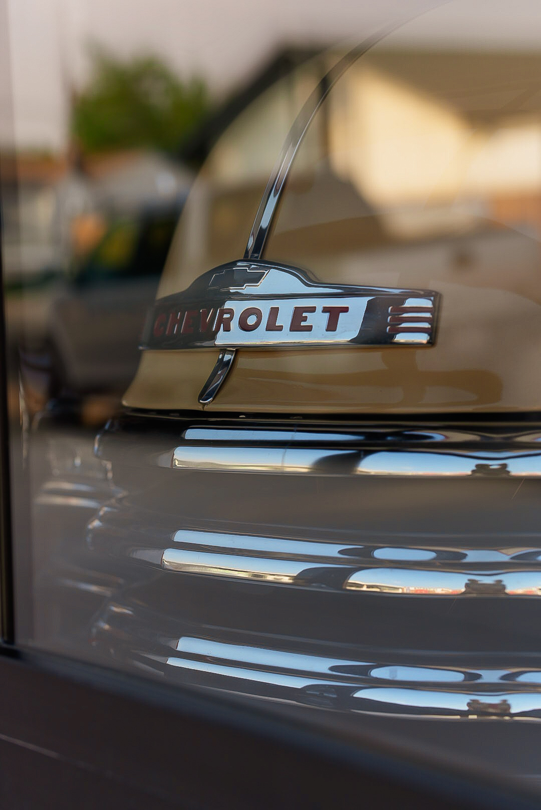 Chrome Chevrolet hood emblem on a restored vintage pickup