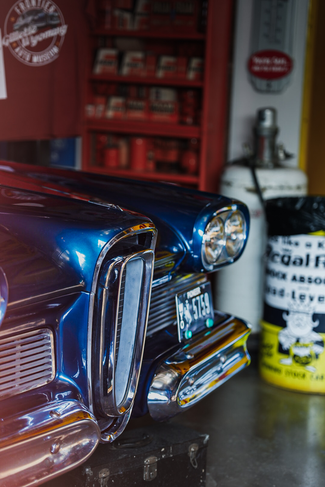 Blue Edsel front end and chrome grille inside a vintage auto museum