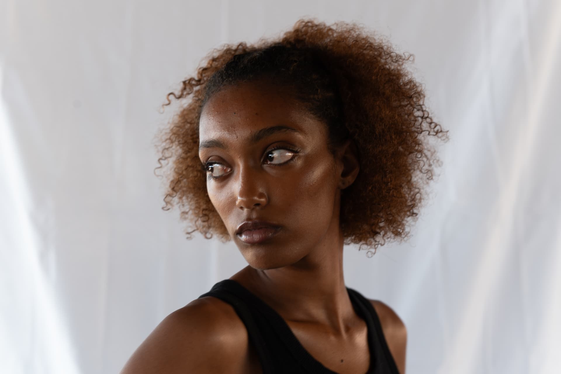 Studio portrait of a woman looking to the side in calm light